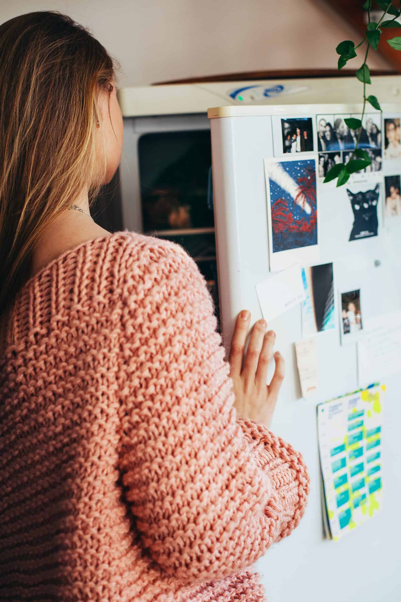 woman-wearing-pink-knit-top-opening-refrigerator-1458687