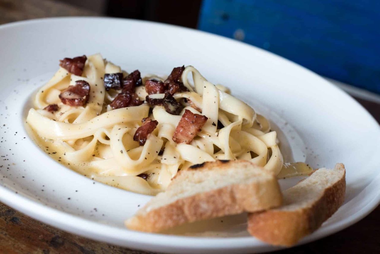 pasta-dish-with-bread-on-white-ceramic-plate-998246